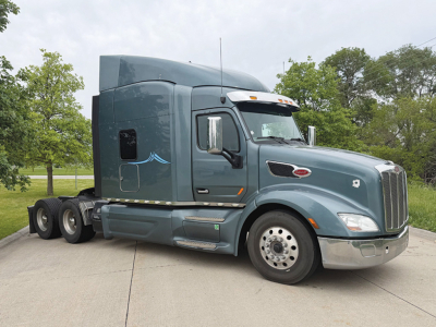 Peterbilt 579 UltraCab tractor 2018 side view showing front grille, sleeper cab, dual rear axles, and chrome mirrors.