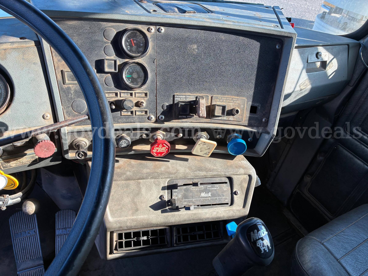 Dashboard and center console of 1992 Mack RD RD690S showing gauges, switches, and ventilation ports