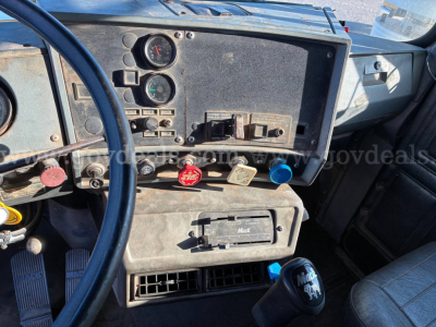 Dashboard and center console of 1992 Mack RD RD690S showing gauges, switches, and ventilation ports