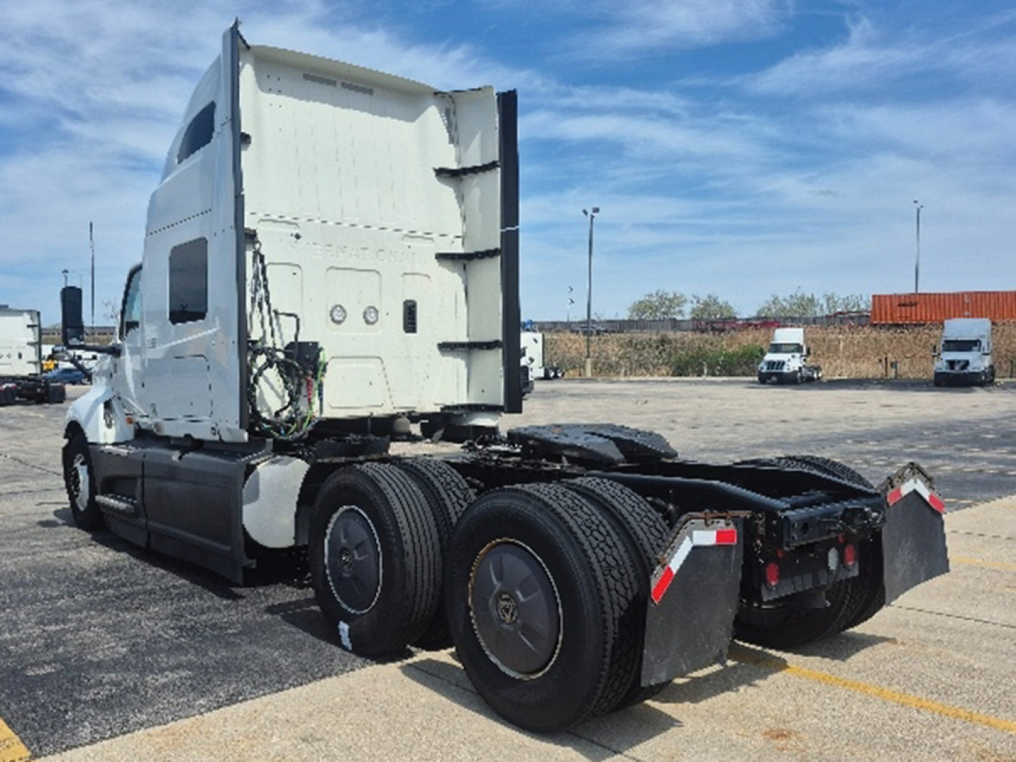 International LT625 truck cab and rear chassis view showing tandem axle configuration with dual rear wheels and fifth wheel area.