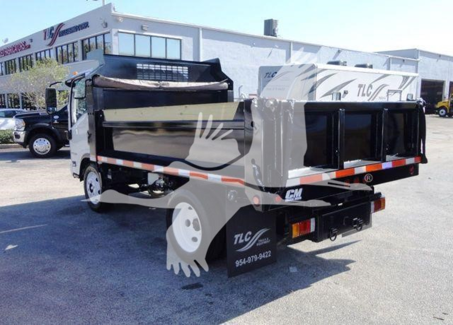 Isuzu NPR-HD dump truck rear and side view showing dump bed and taillights with TLC branding.
