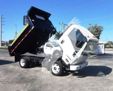 Isuzu NPR HD dump truck with lifted dump bed in a lot.