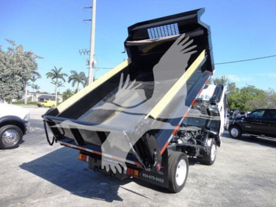 Isuzu NPR-HD dump truck bed raised showing cargo area and hydraulic mechanism with damaged tailgate.