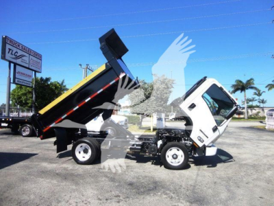 Isuzu NPR-HD dump truck with bed raised showing dumping mechanism and side view of cab.