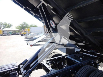 Isuzu NPR-HD dump truck underbody view showing hydraulic dump mechanism and frame components.