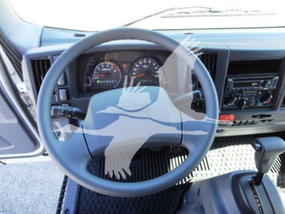 Isuzu NPR-HD truck interior steering wheel and dashboard visible from driver’s seat.