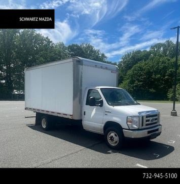 Ford E-Series Cutaway box truck with large cargo box, white cab, in a parking lot.