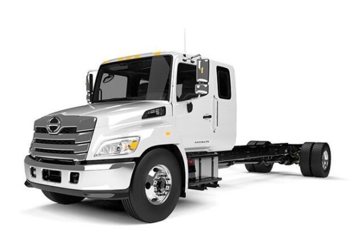 Truck chassis showing front of a white 2025 Hino L6 tow truck with extended cab and chassis, no bed attached.