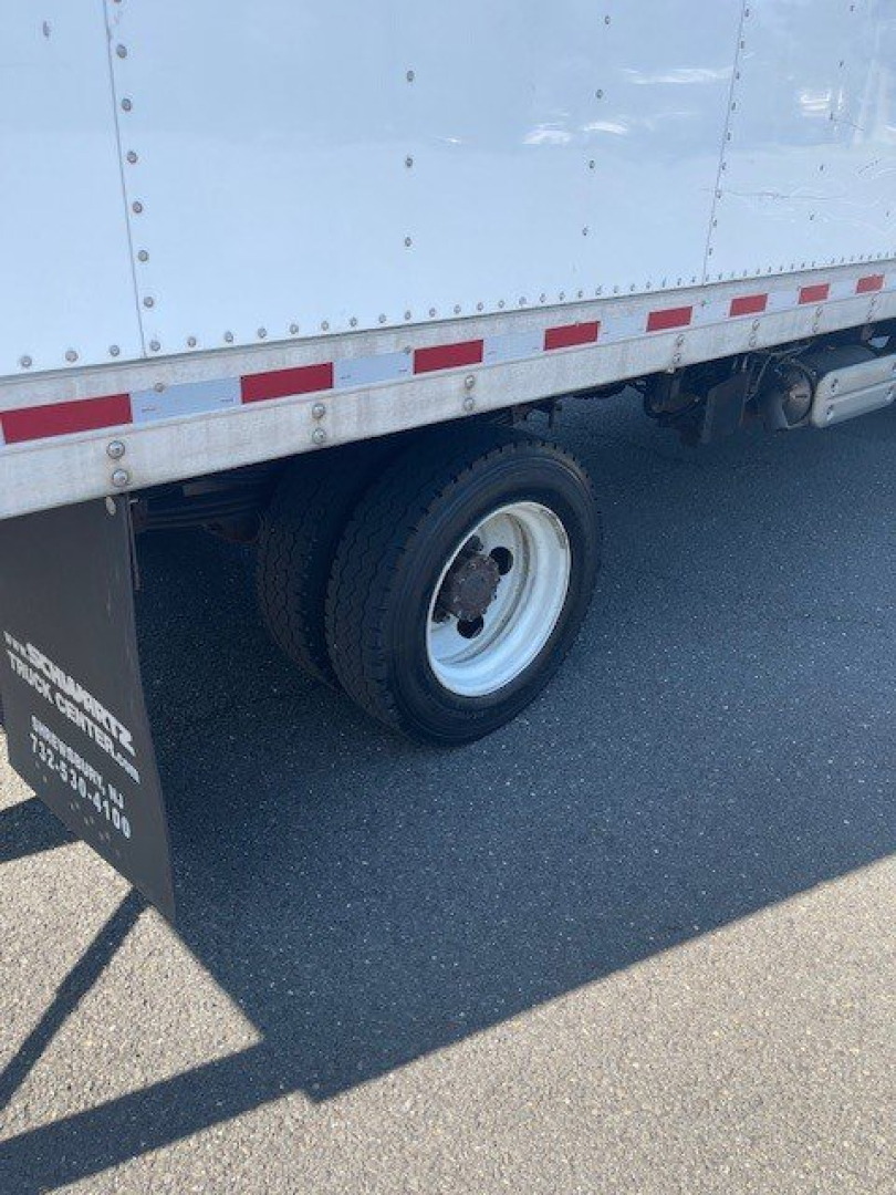 Truck wheel area of a 2018 Hino 155 box truck showing a single rear wheel and mudflap with small white text