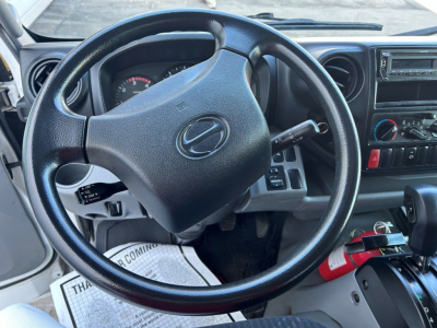 Steering wheel view of 2018 Hino 155 interior showing dashboard controls and gear selector.
