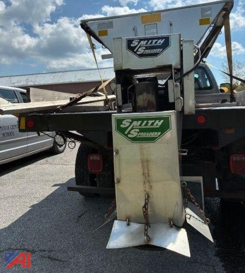 Rear view of a 2009 Ford F350 Super Duty salt spreader truck with Smith Salt Spreaders branding on the spreader attachment mounted at the back.