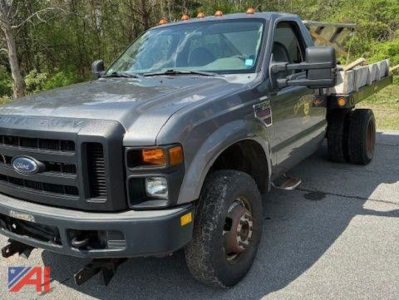 2009 Ford F350 Super Duty salt spreader truck showing front-left view with gray cab and salt spreader bed.