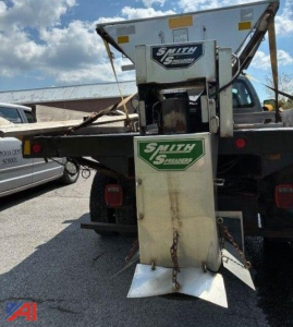 Rear view of a 2009 Ford F350 Super Duty salt spreader truck with Smith Salt Spreaders branding on the spreader attachment mounted at the back.