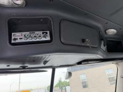 Dashboard interior showing radio panel and overhead console in Freightliner Cascadia cab with keys in ignition.