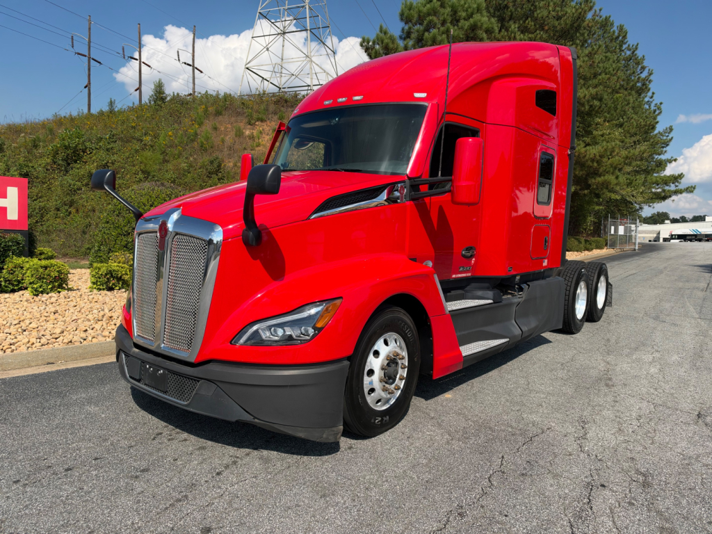 Kenworth T680 truck in red color, front three-quarter view showing cab and sleeper, with VIN and stock number not visible in image.