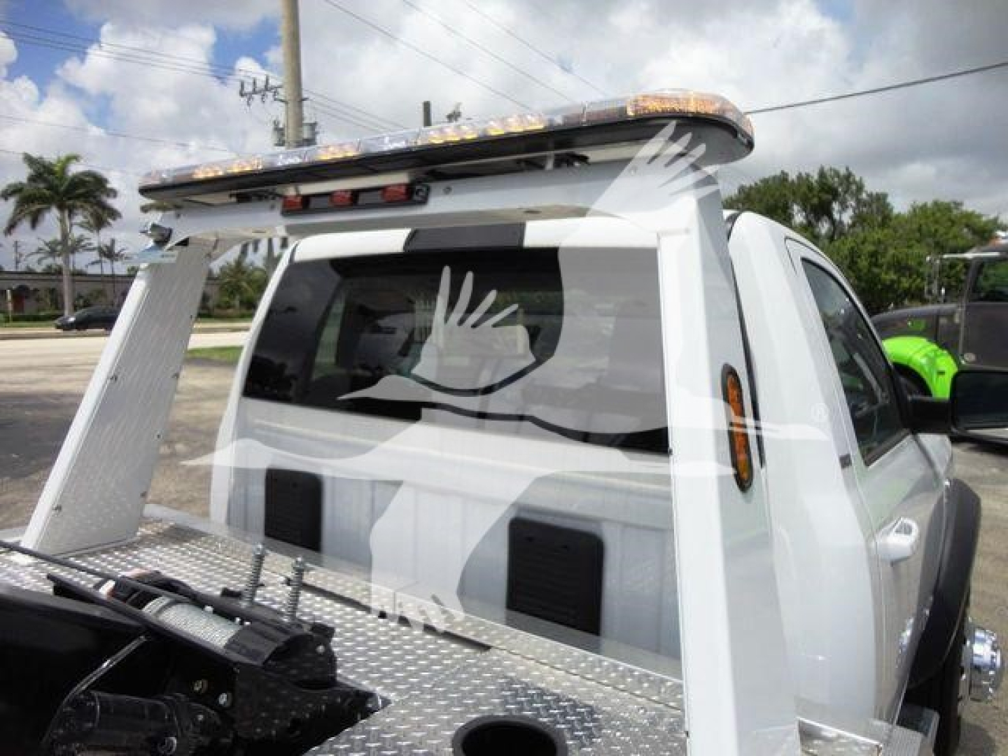 Ram 4500 pickup with flatbed and mounted winch rack in rear view showing canopy and chrome grille text not visible.
