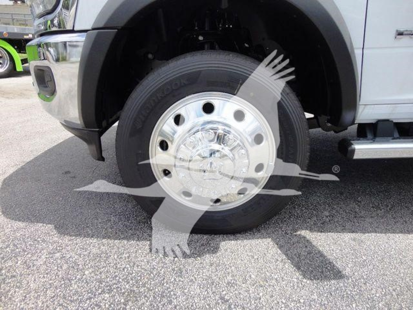 Wheel and tire on a Ram 4500 front corner showing chrome hubcap and tire sidewall with Hankook branding visible.