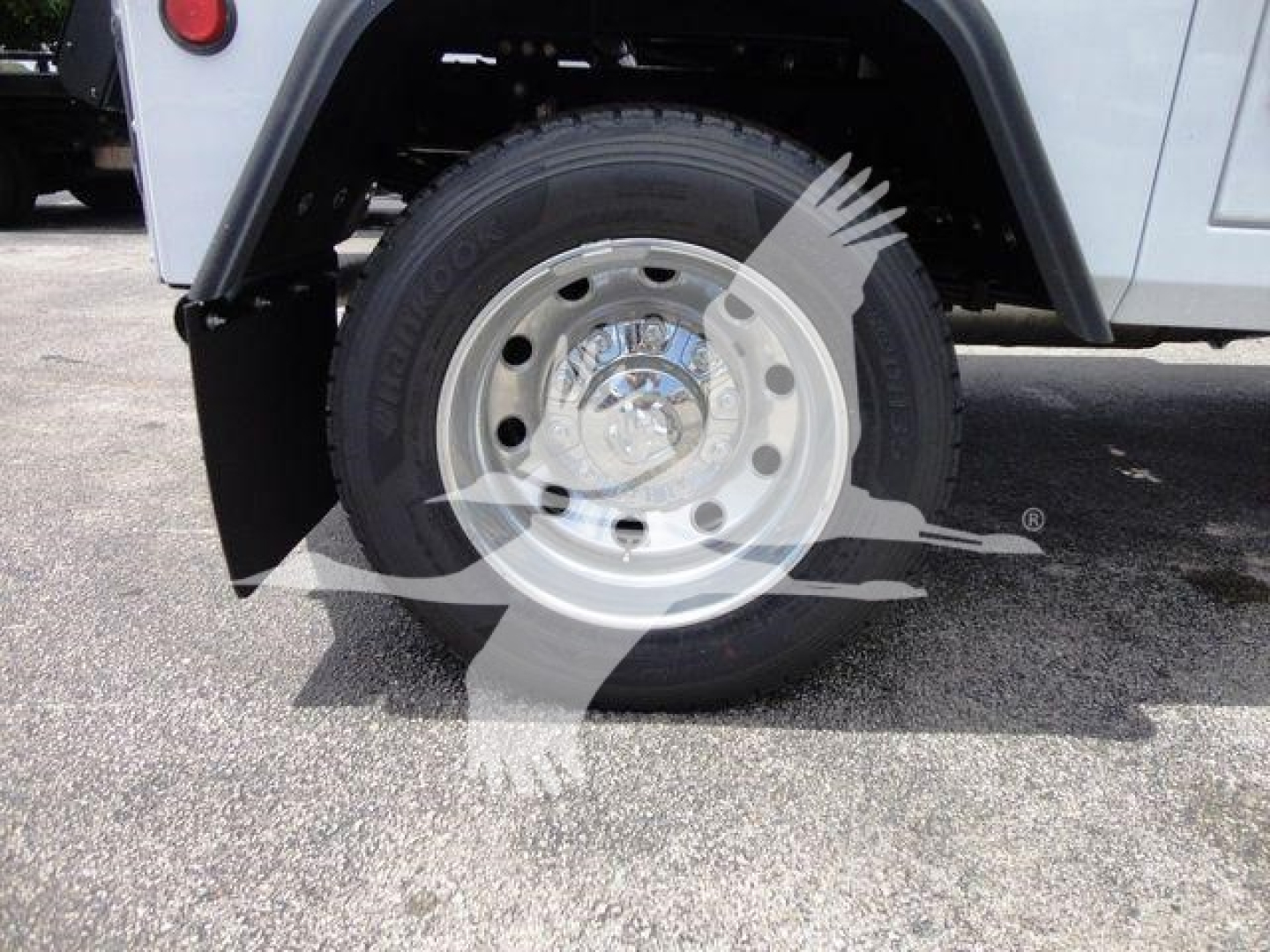 Ram 4500 front wheel well and tire with factory steel wheel and hubcap, fender and underbody splash guard visible.
