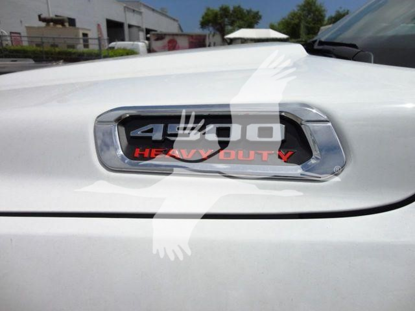 Ram 4500 Heavy Duty badge on white truck hood with chrome surround and 4100 look-alike text.