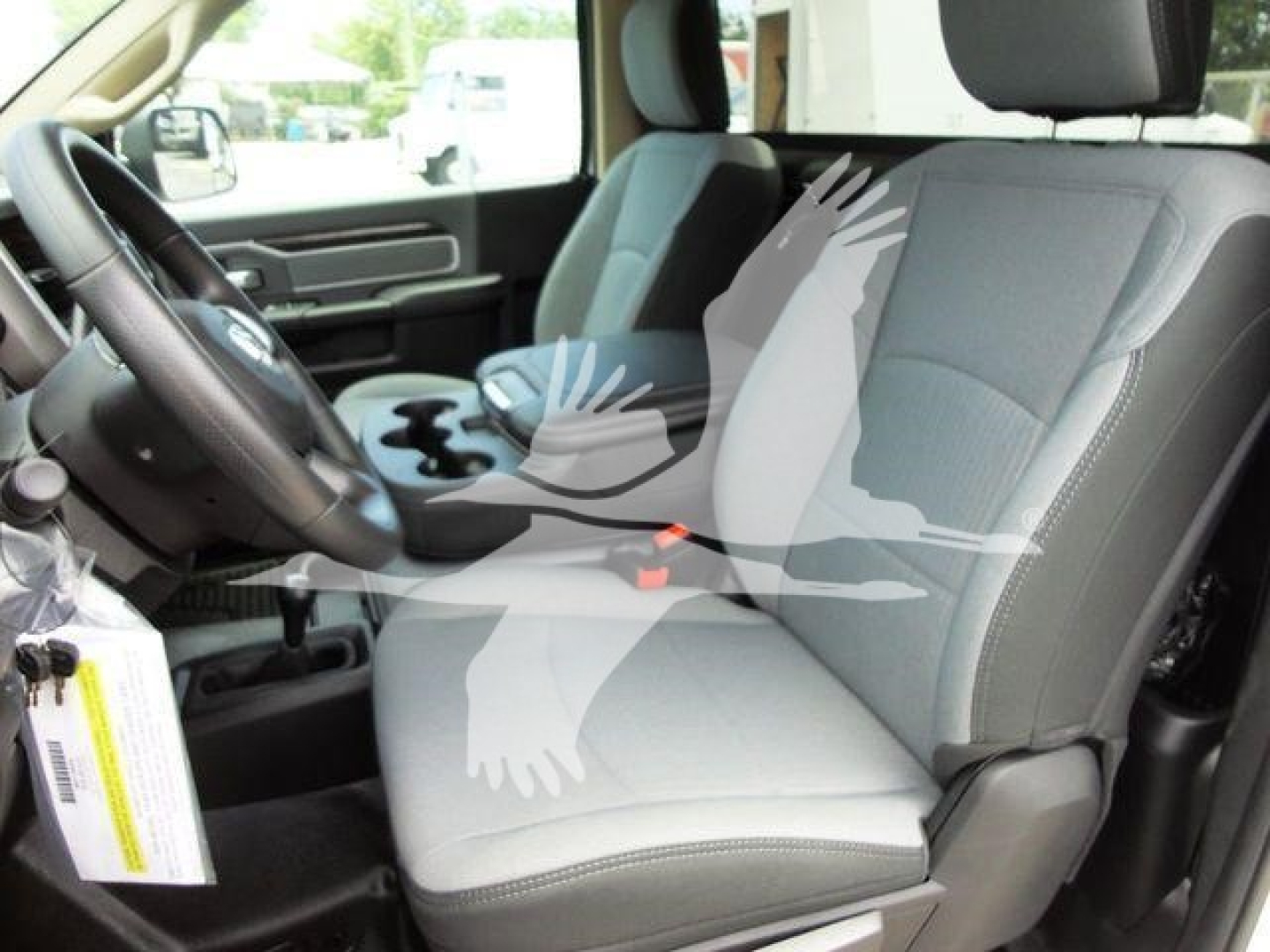 Interior of a 2024 Ram 4500 SLT pickup truck showing front seats, steering wheel, and center console from the driver side.