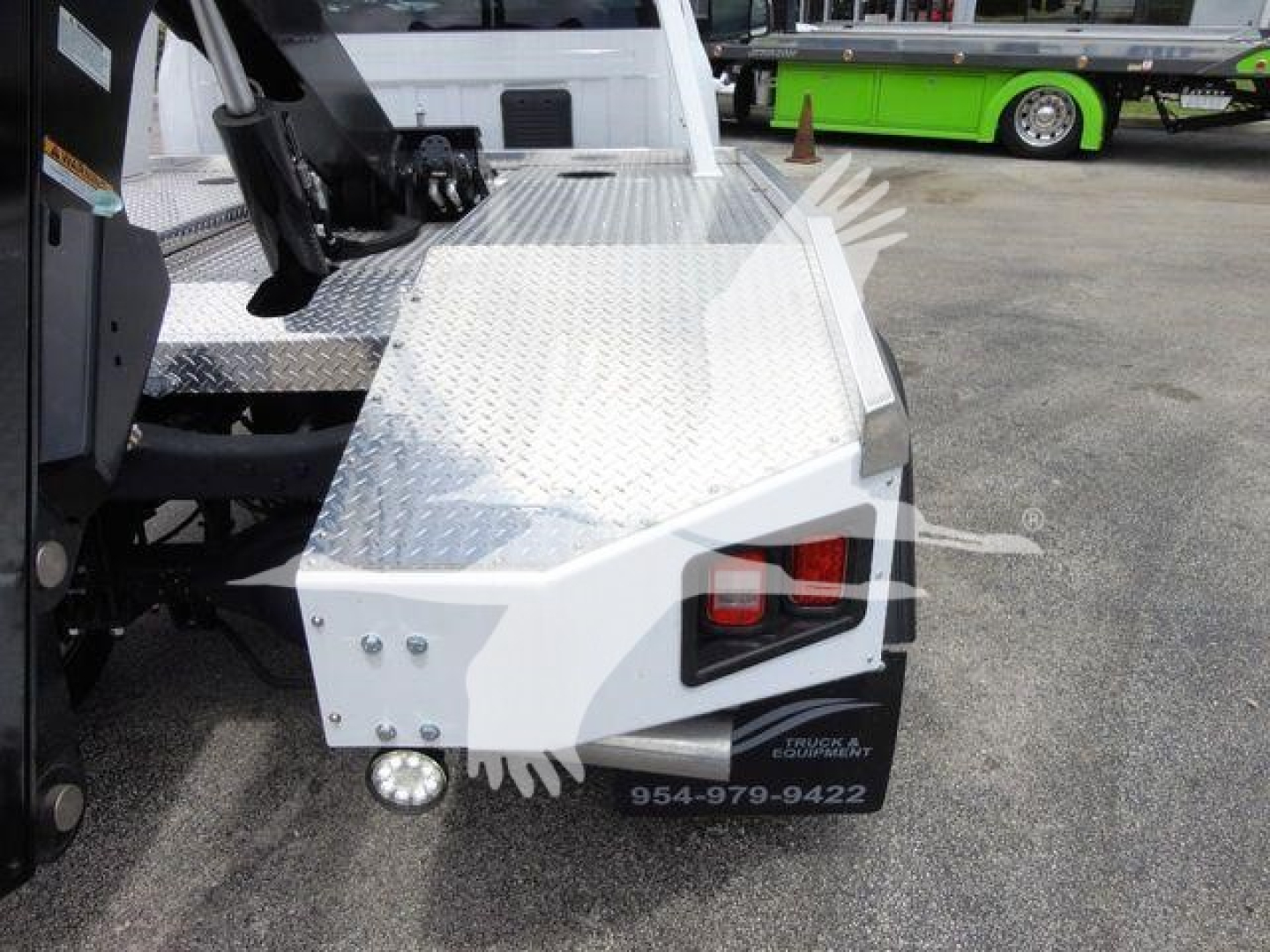 Trucks showing front-right platform with diamond plate metal step and tow winch system on Ram 4500 SLT. Visible bumper lights and black fender area.