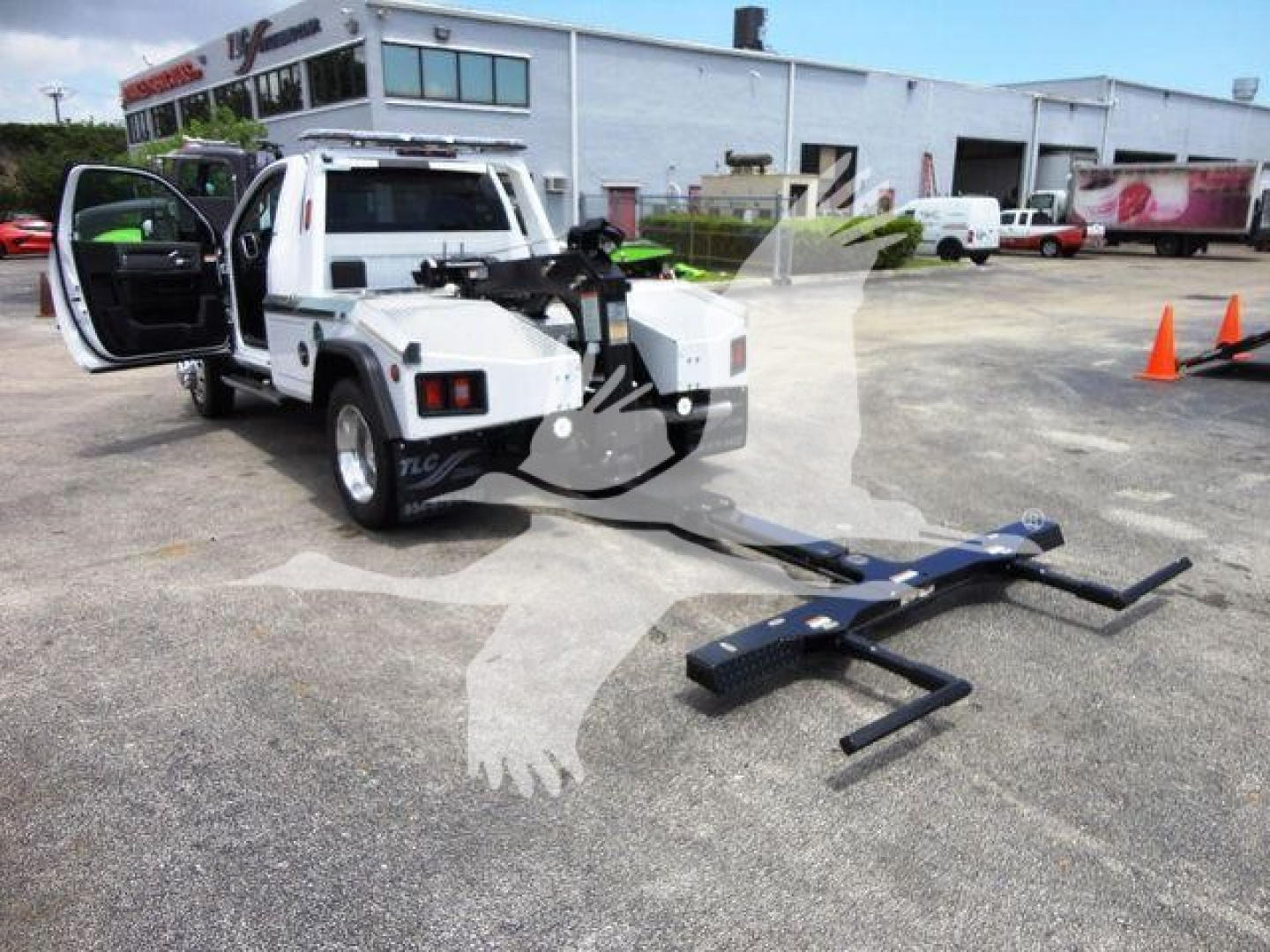 2024 Ram 4500 SLT winch truck with front equipment extended, doors open, outdoor dealership lot in background