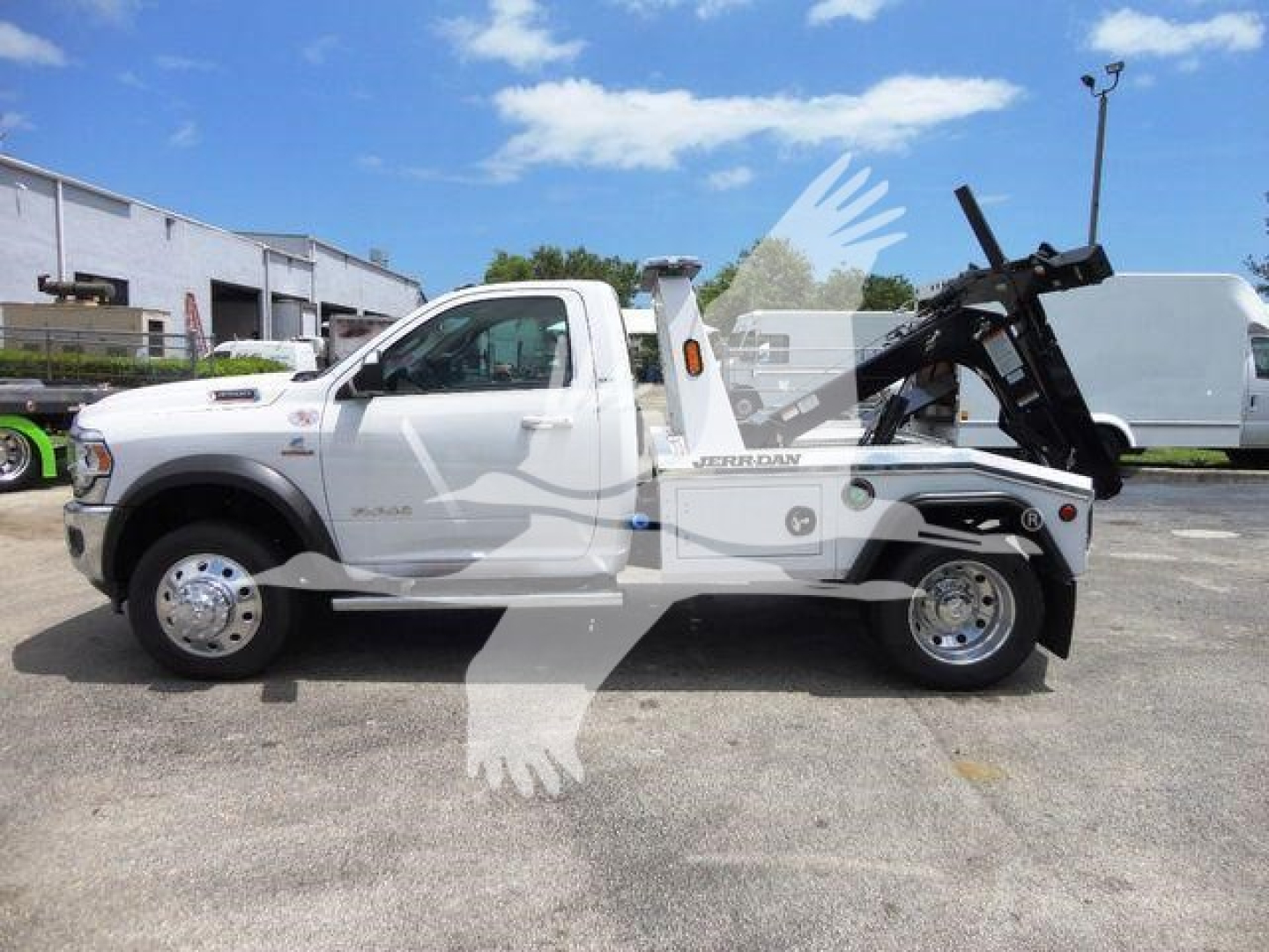 Ram 4500 tow truck side view showing wheel-lift and winch assembly with branding visible on door and fender
