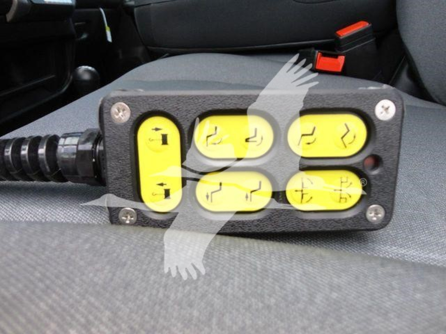 Winch controller with six yellow buttons arranged 3x2 on a black housing mounted in a vehicle interior.
