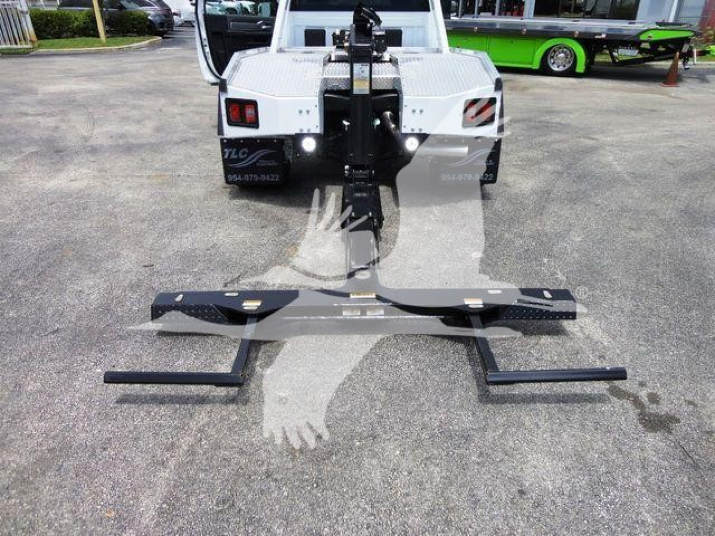 Ram 4500 winch setup showing front mount with black winch bar and mounting hardware on pavement.