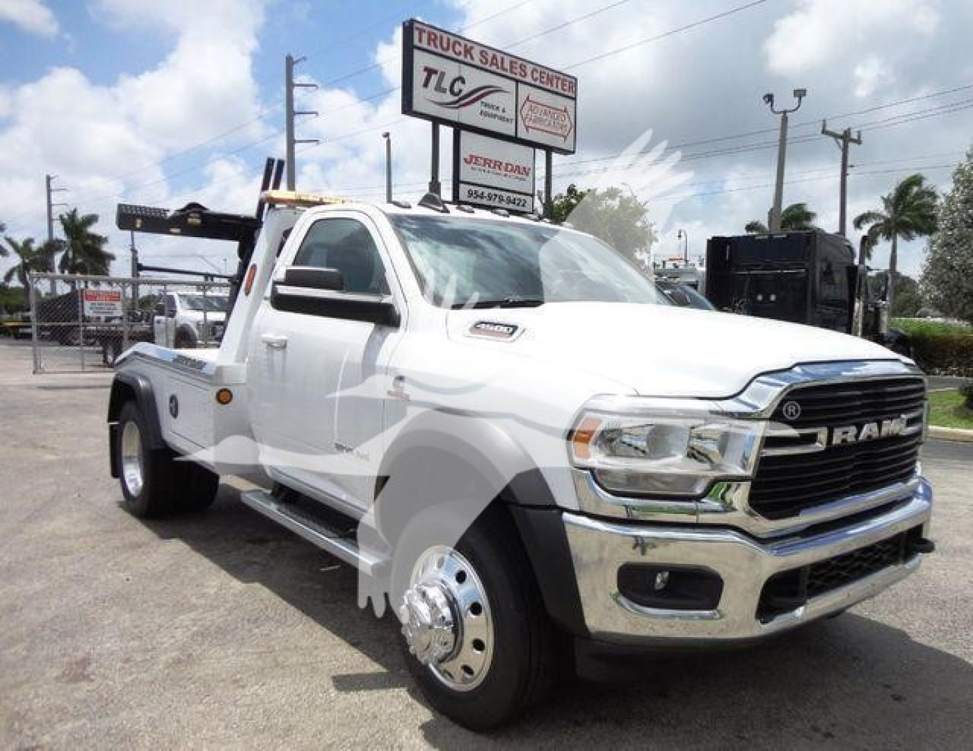 Ram 4500 truck in white with front chrome grille and winch setup, side tow hook, heavy-duty rear axle, and dual rear wheels.
