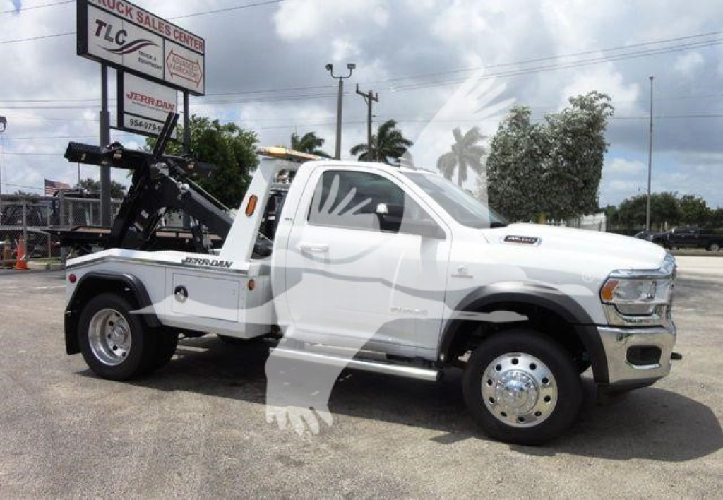 2024 Ram 4500 SLT tow truck - white dual-wheel pickup with hydraulic winch in rear bed, stock number J68869, TLC sign in background