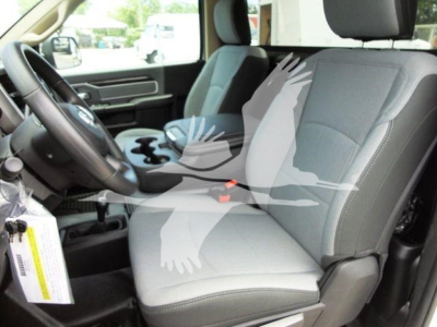 Interior of a 2024 Ram 4500 SLT pickup truck showing front seats, steering wheel, and center console from the driver side.