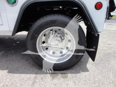 Truck wheel and fender showing steel wheel, tire, and mud flap on RAM 4500 SLT winch listing.