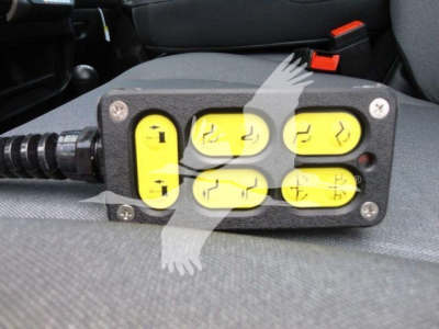Winch controller with six yellow buttons arranged 3x2 on a black housing mounted in a vehicle interior.