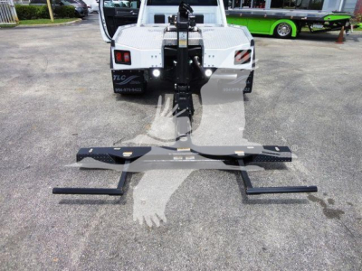 Ram 4500 winch setup showing front mount with black winch bar and mounting hardware on pavement.