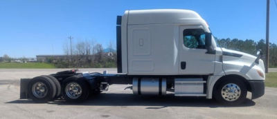 Truck chassis and cab of a 2022 Freightliner Cascadia 126 sleeper tractor, side view with chassis and rear axles visible.