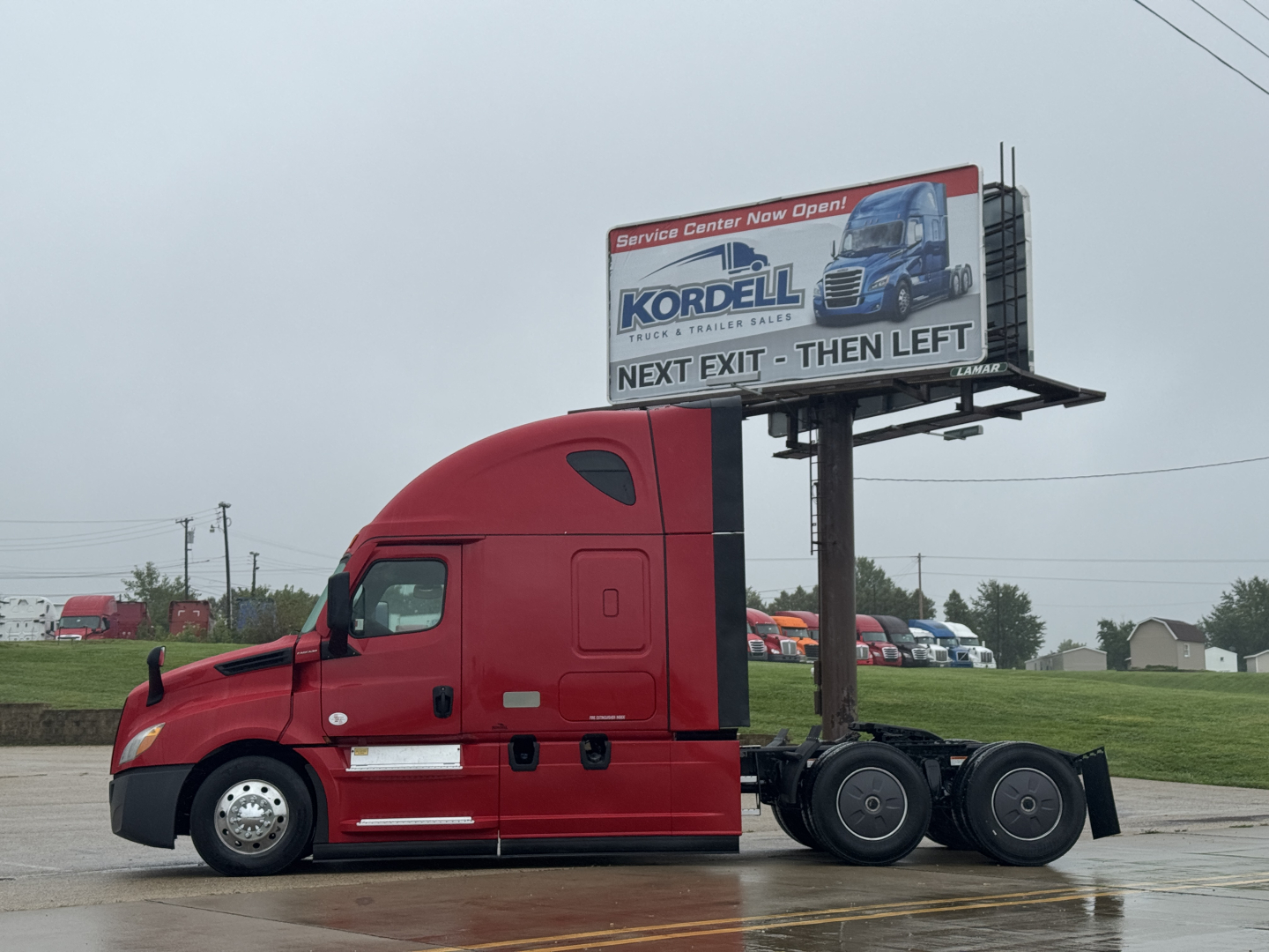 Freightliner Cascadia 126 sleeper tractor with red cab and billboard trailer hardware visible.