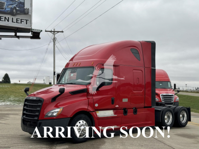 Truck cab side view showing red Freightliner Cascadia 126 sleeper with curved hood and aerodynamic mirrors.