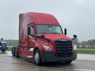 Freightliner Cascadia 126 semi-truck front-left view showing red cab, black grille, and large dual rear axles.