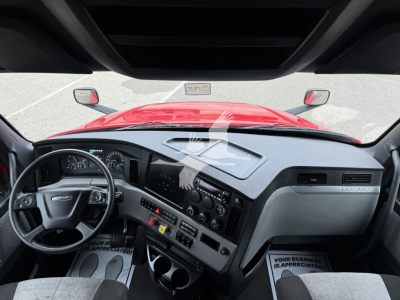 Freightliner Cascadia interior dashboard and steering wheel view from driver seat showing controls and gauges.