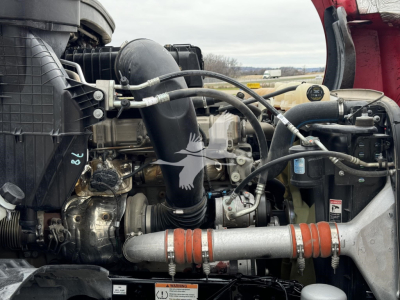 Freightliner Cascadia engine bay showing intake hose, turbo, intercooler piping, and various hoses.