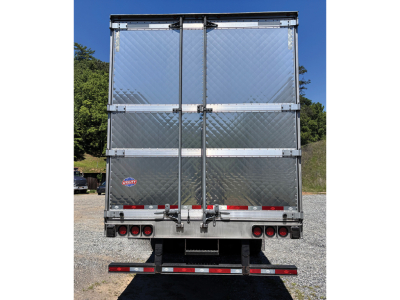 Rear view of a 2024 Utility 3000R trailer with diamond plate aluminum doors and taillights.