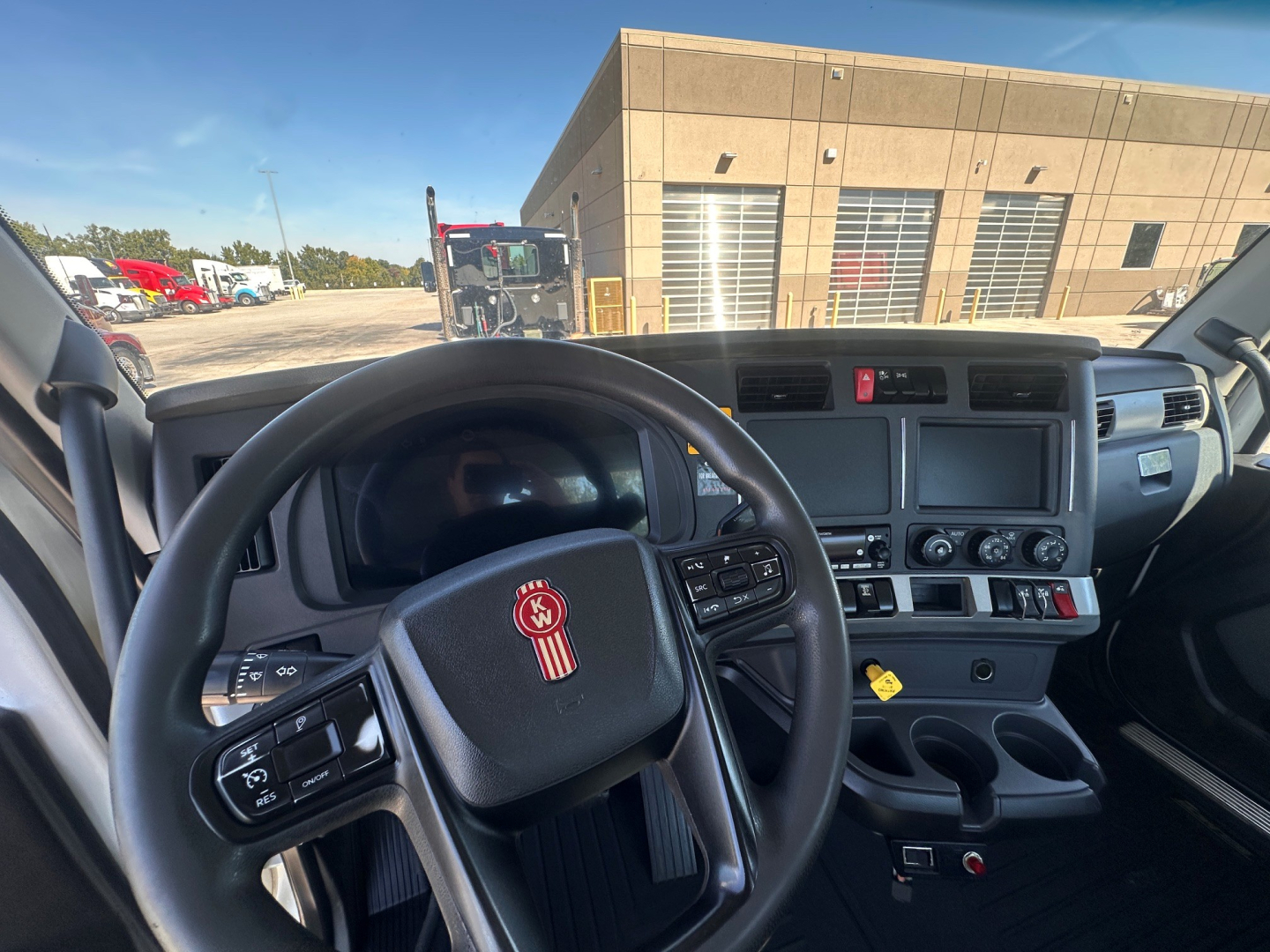 Dashboard view of 2022 Kenworth T880 cab interior with steering wheel, monitor cluster, and control panel. Visible text includes VIN 1XKZD49X6NJ148064 and stock number 0632196 on listing data.