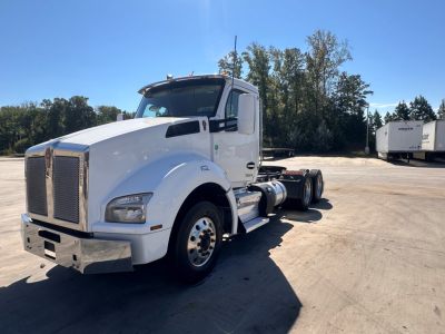 Kenworth T880 Daycab tractor in white, side view, with dual rear axles and chrome front grille.