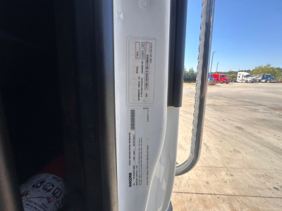 Truck door jamb with VIN label and barcode on a Kenworth T880 conventional daycab showing vehicle identification labels