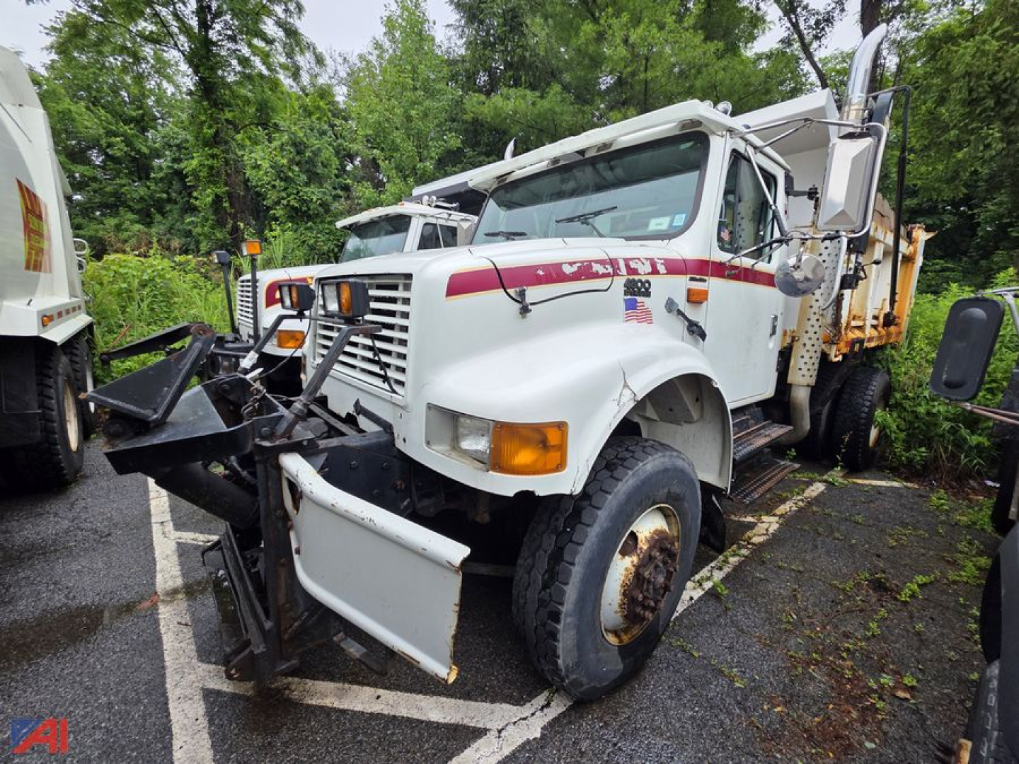 International 4800 dump truck in-service showing front plow and warning lights.