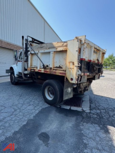 Dump truck bed and rear view of an International 4800 dump truck showing rusted dump body and dual rear wheels.