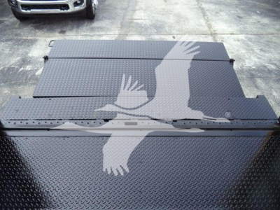 Box truck bed top with Diamond plate pattern and a large graphic silhouette of two birds in flight overlaying the surface.