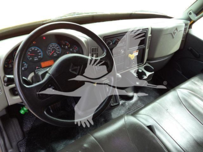 Truck interior showing steering wheel, dashboard, and center console of a 2018 International Durastar 4300 with black leather seats and a touchscreen display.