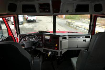 Dashboard and steering wheel of a 2019 Western Star 5700XE truck cab interior showing instrument cluster, center console, and windshield.